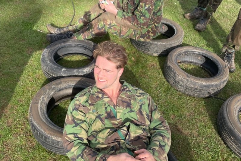 Man lying back on an old tyre