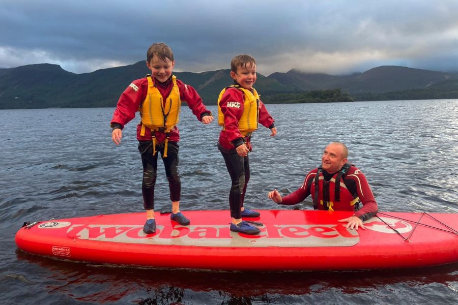 Two children on a paddle board on Derwentwater