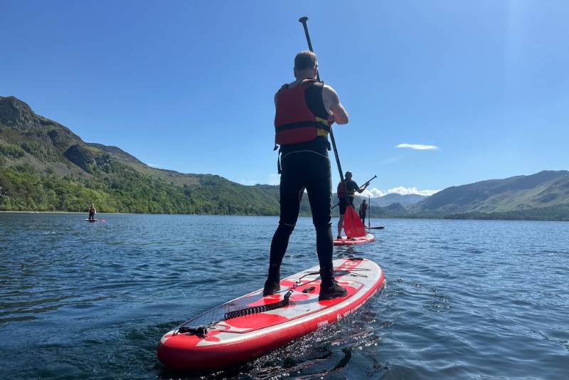 Man paddle boarding in the lake district