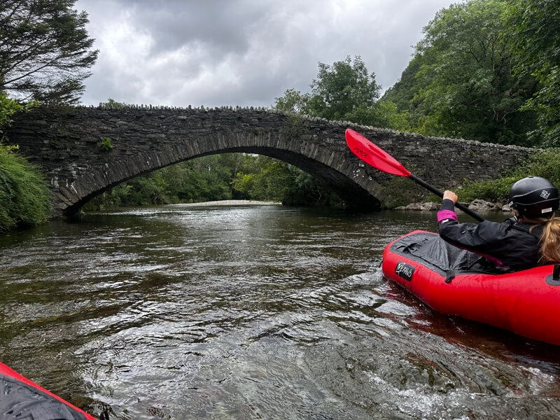 Packrafting under a bridge