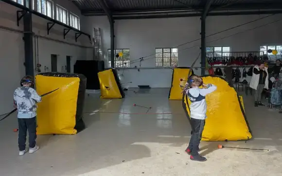 Children playing battle archery