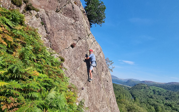 Man climbing up a Lake District cliff