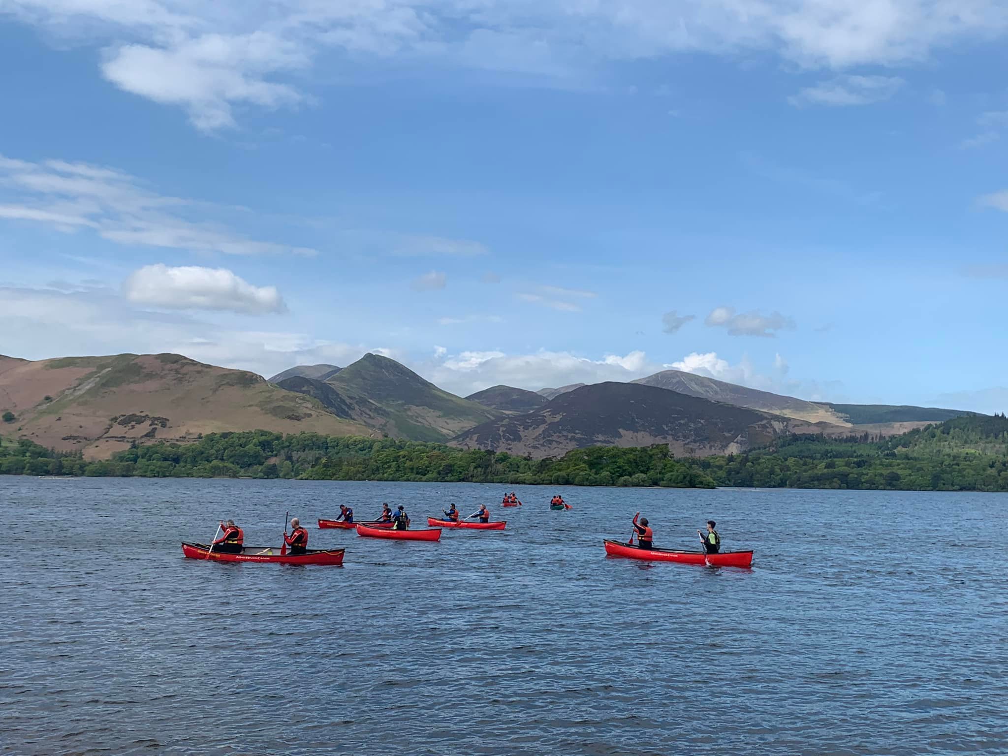 Group canoeing on Derwentwater in summer