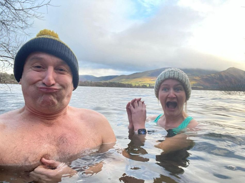 Becca and Lee pulling faces in the cold water of Derwentwater