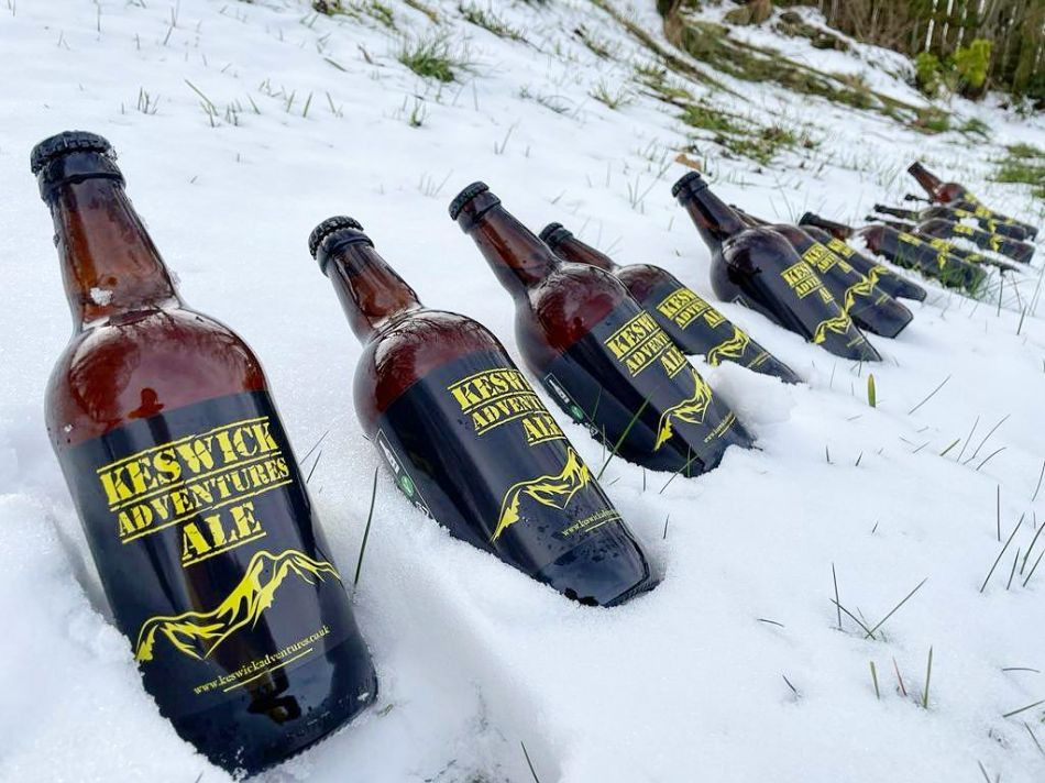 Bottles of Keswick Adventures Ale in the snow