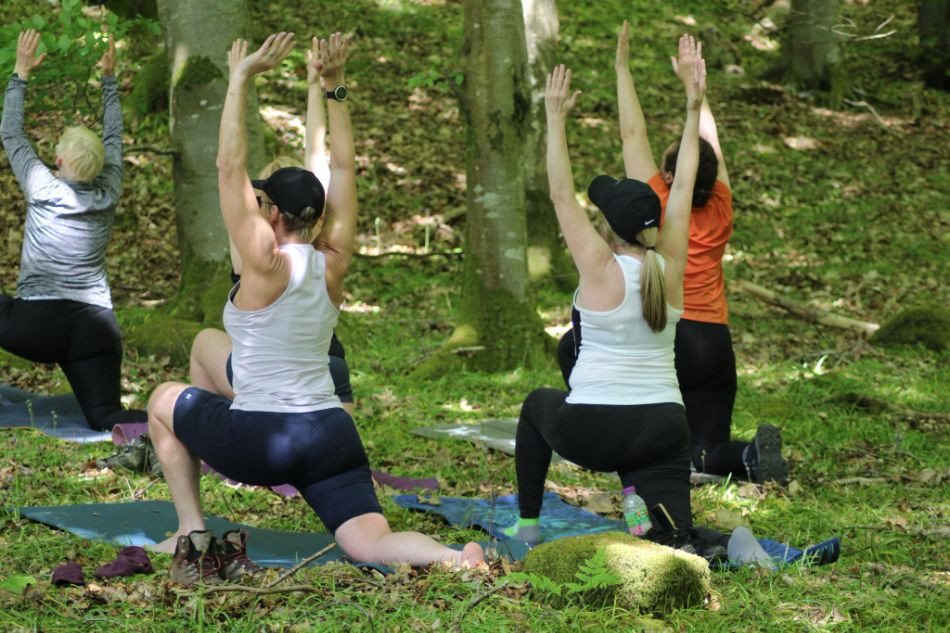 Women doing yoga in the woods