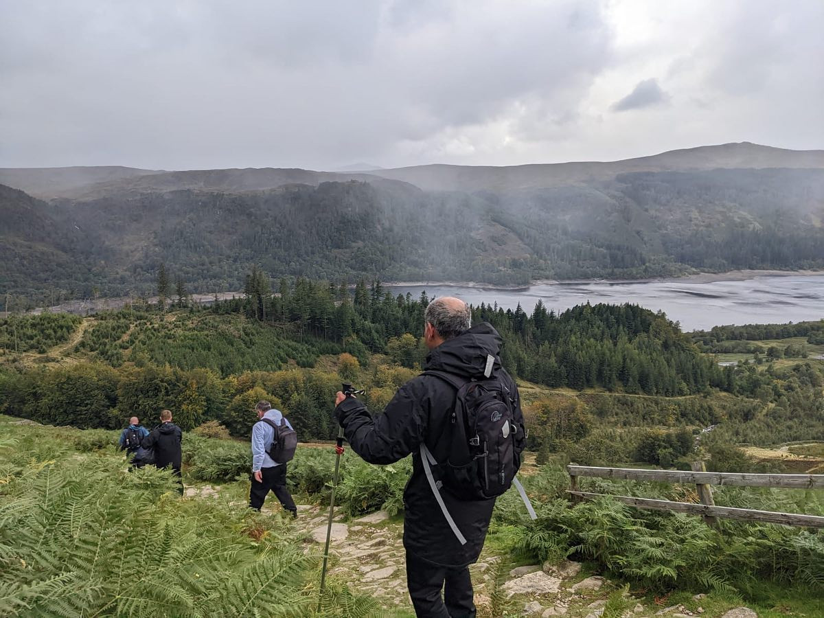 Group of men hiking over Helvellyn in the Lake District