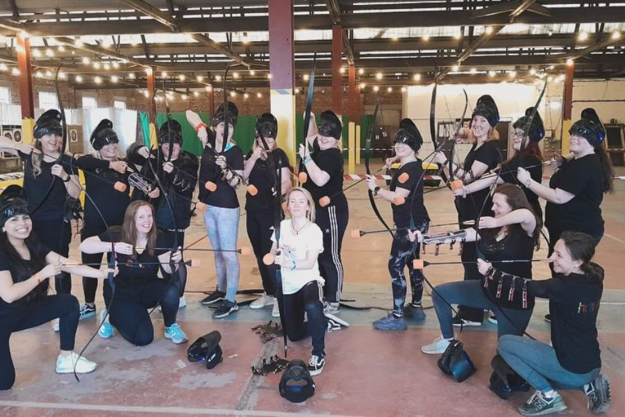 Group of women posting with bows and arrows