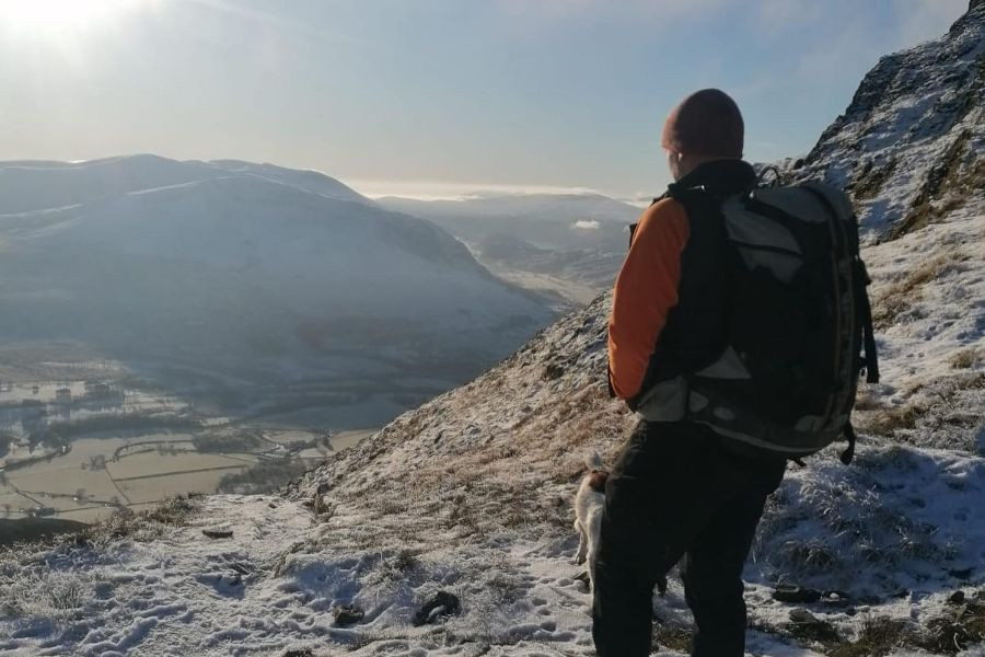 Man standing on a mountain near Keswick in the snow