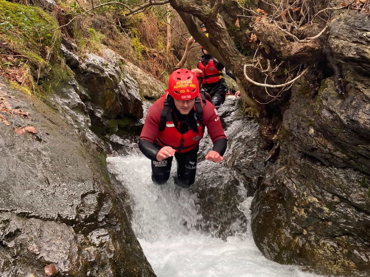 A man jumping into a pool while ghyll scrambling in the lake district