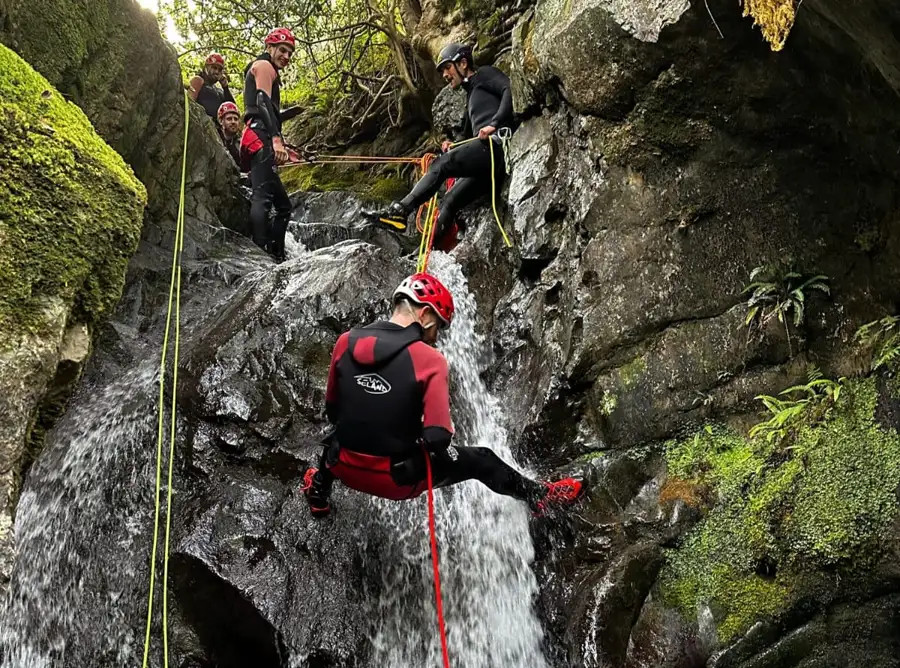 man-abseiling-waterfall