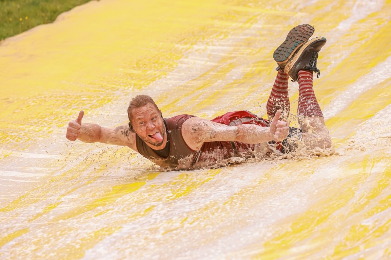Man sliding down a water slide at Gelt Gladiator