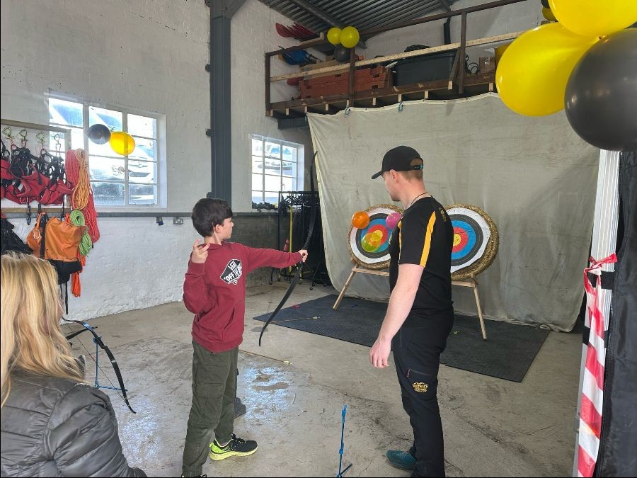 Boy shooting an arrow at targets